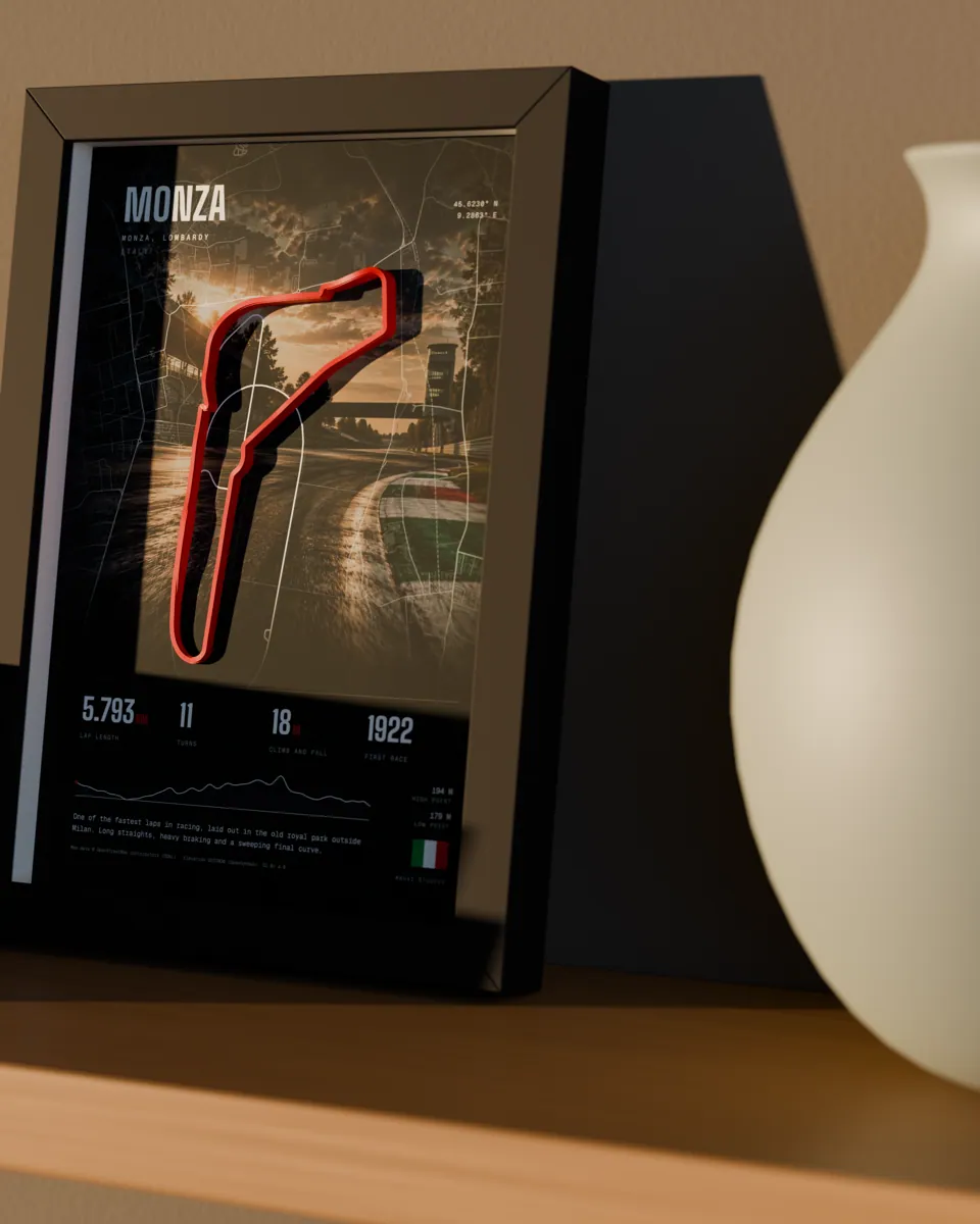 A small framed race-track relief on a wooden shelf beside a ceramic vase